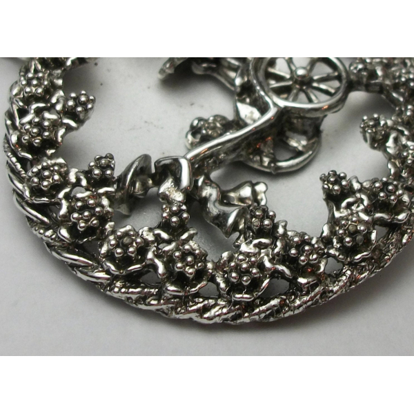 Close-up of vintage silver Asian rickshaw pendant
