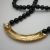 back of vintage Trifari black enamel and gold bar necklace