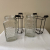 Clear Honeycomb Glass Jars Bottles in Metal Holders Stands Flower Vases